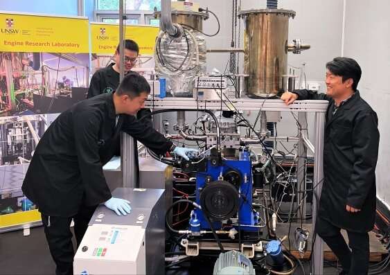 An image of the team from UNSW, standig next to the Hydrogen-Diesel Direct Injection Dual-Fuel System.