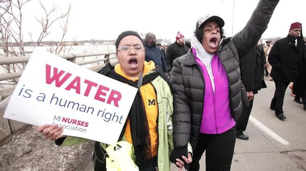 People participate in a national mile-long march in February to highlight the push for clean water in Flint, Mich.