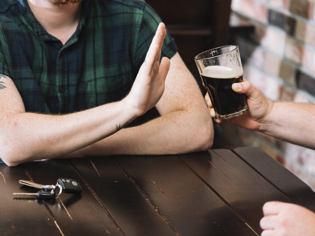 Man Refusing Glass Rum Offered By His Friend 1024x767