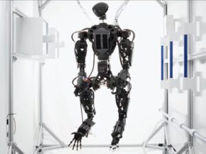A space humanoid uses four arms to assist astronauts